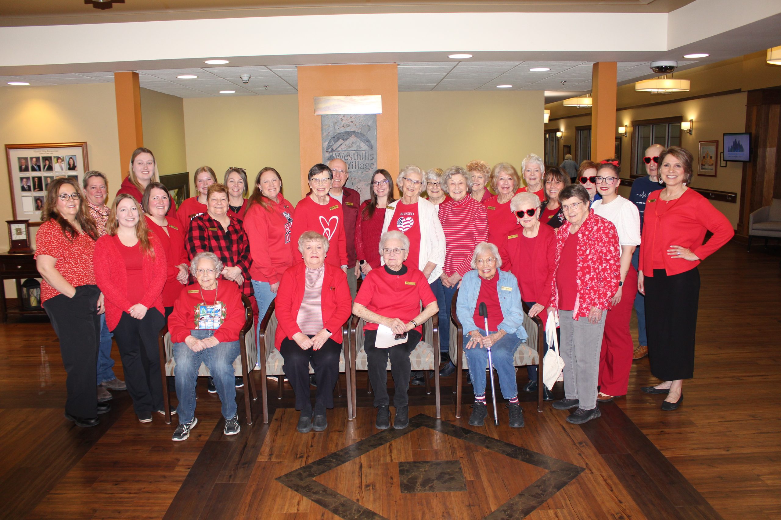 Westhills Village employees and residents dressed in red clothing